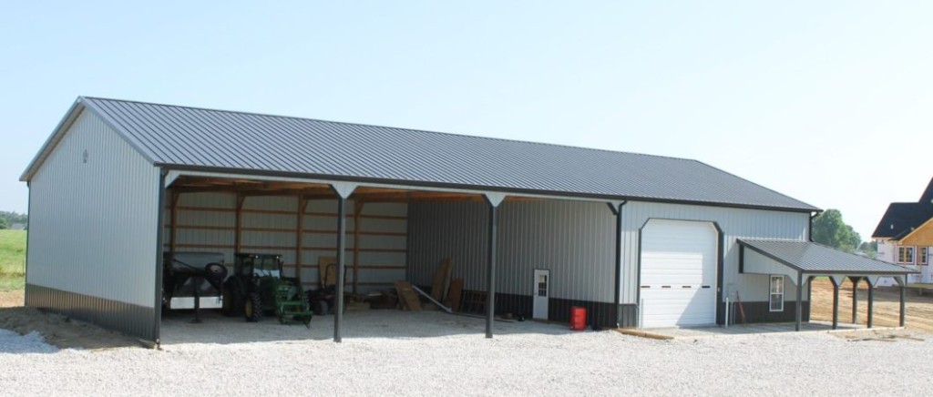 Three-sided pole shed with open bays for equipment and material storage.