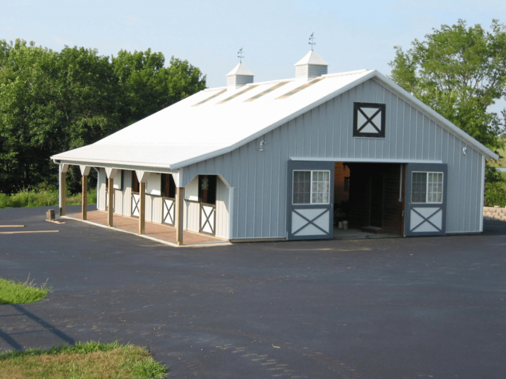 Post-frame building with Touch of Class sliding doors featuring decorative crossbuck styling.