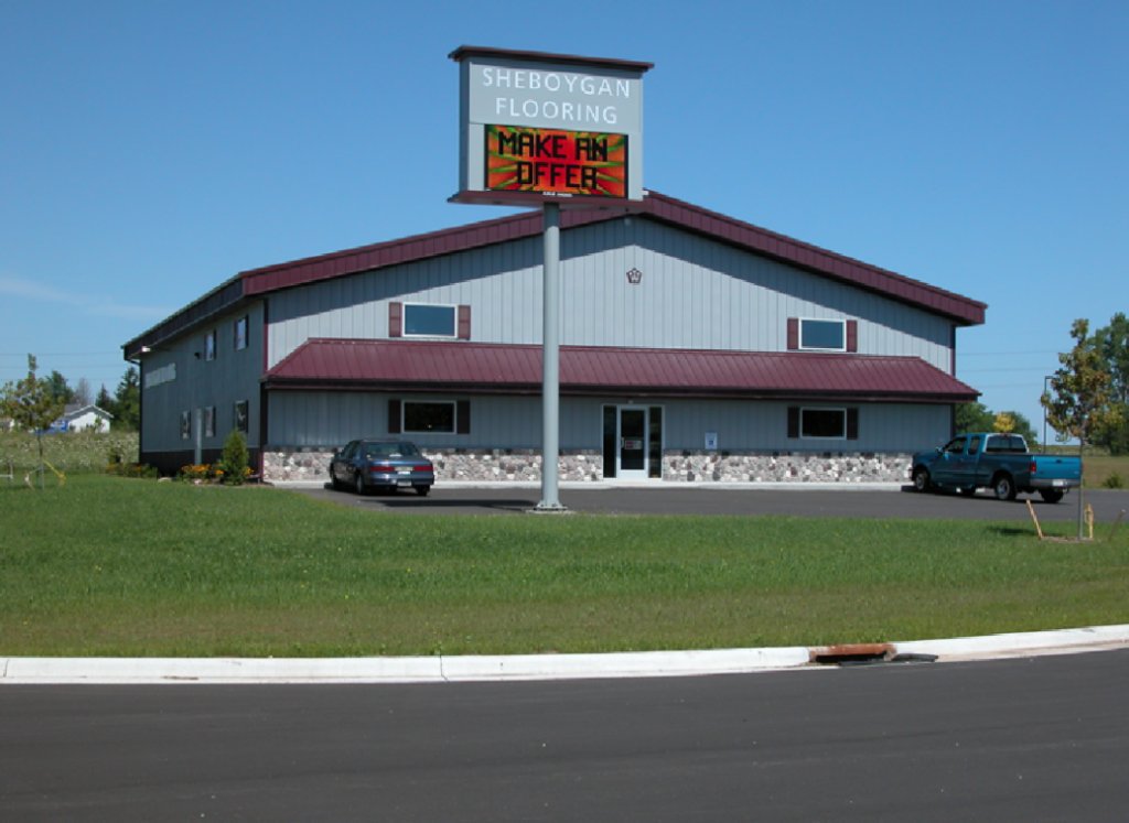 Two-story post-frame building with metal siding, large overhead doors, and a raised upper level.