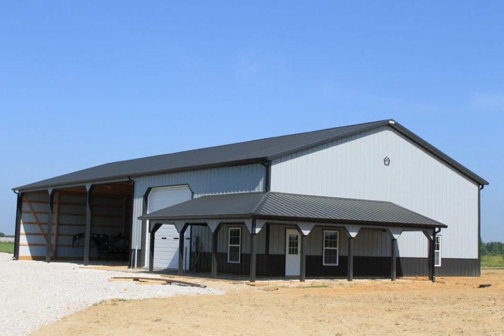 Post-frame building with a wraparound Dutch porch and covered entry area.