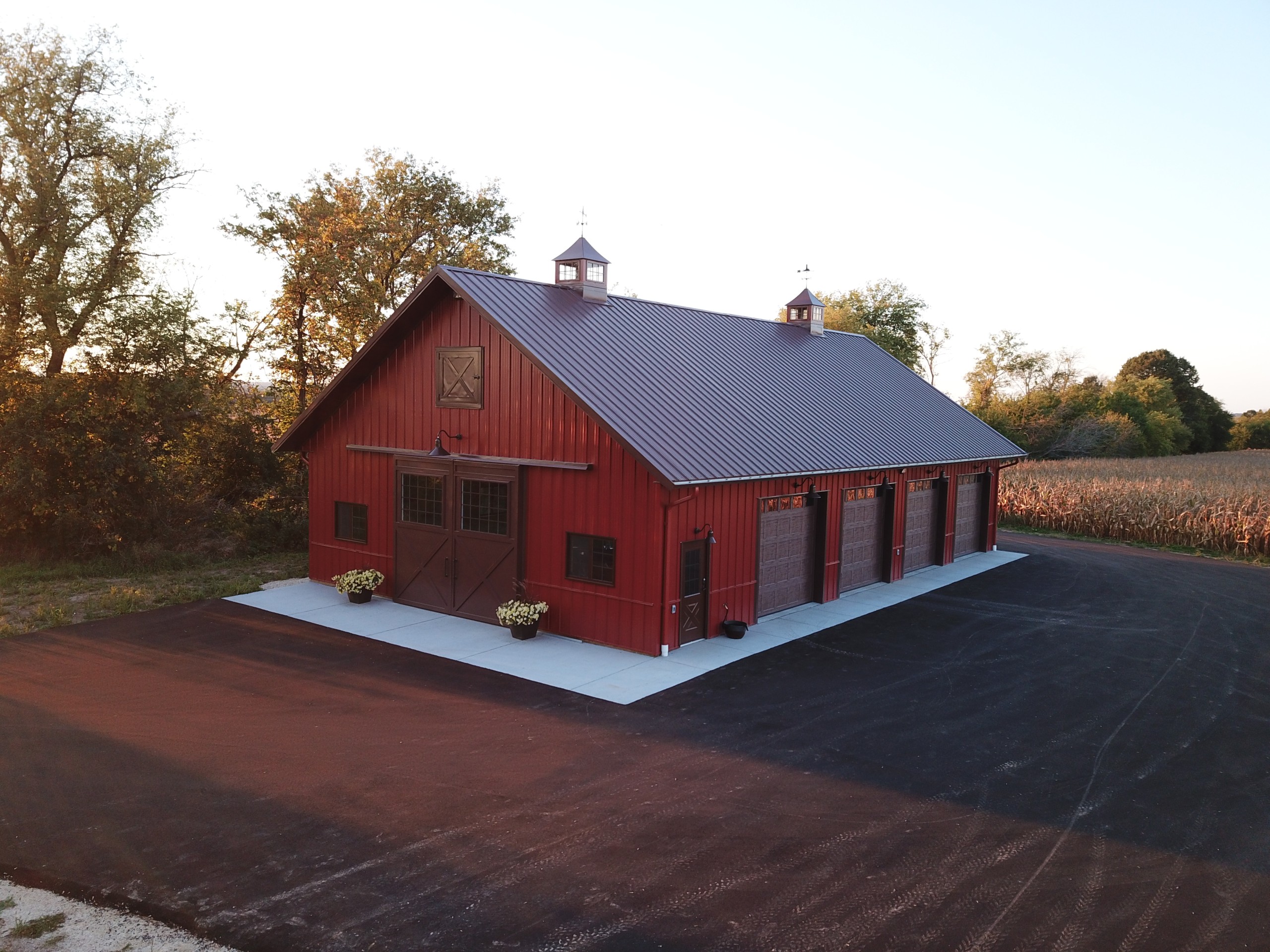 Aerial view of custom machinery storage building with two illuminated functional cupolas