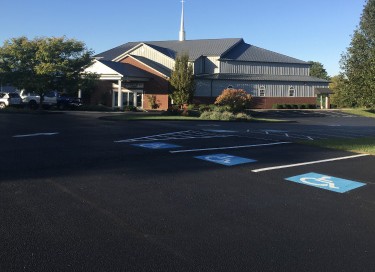 Ninevah Christian Church with steel siding, steeple, covered entrance, and parking lot in Kentucky