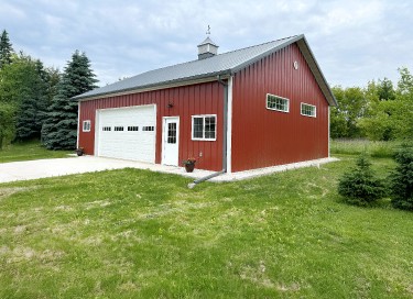 36x40 garage with red steel siding, overhead garage door, cupola, and windows in Wisconsin