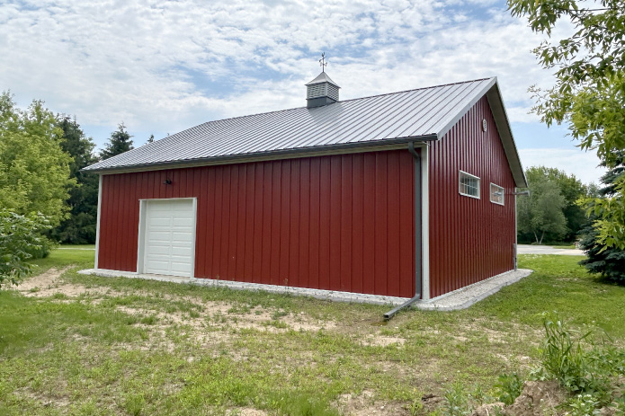 Red Steel Siding With Charcoal Roofing