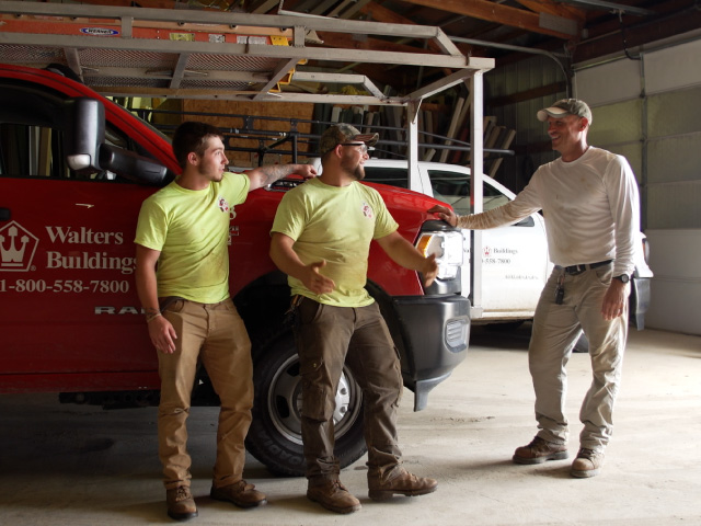 Walters Crew Members Talking Next to a Company Truck Walters Crew Members Talking Next to a Company Truck