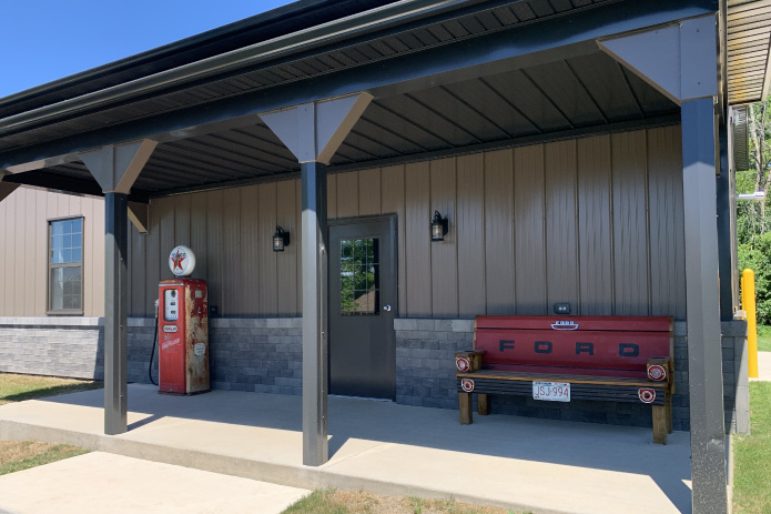 Front Covered Porch With Retro Gas Pump and Bench
