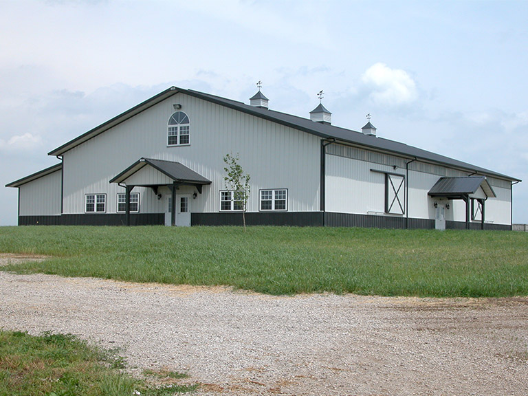 Riding Arena With White Siding and Gray Roof