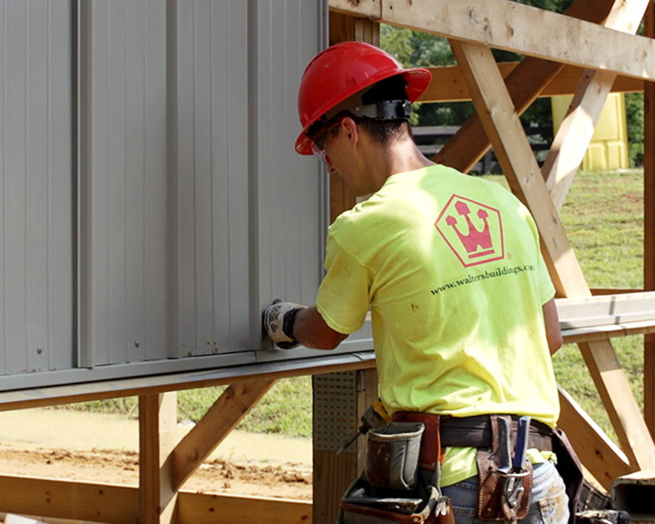 Wlaters Buildings Crew Member Working on Siding