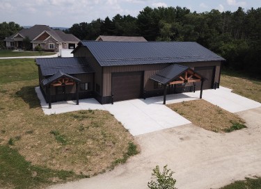 Gable entrance storage building with office space, timber truss entries, steel siding, and overhead garage doors in Ohio