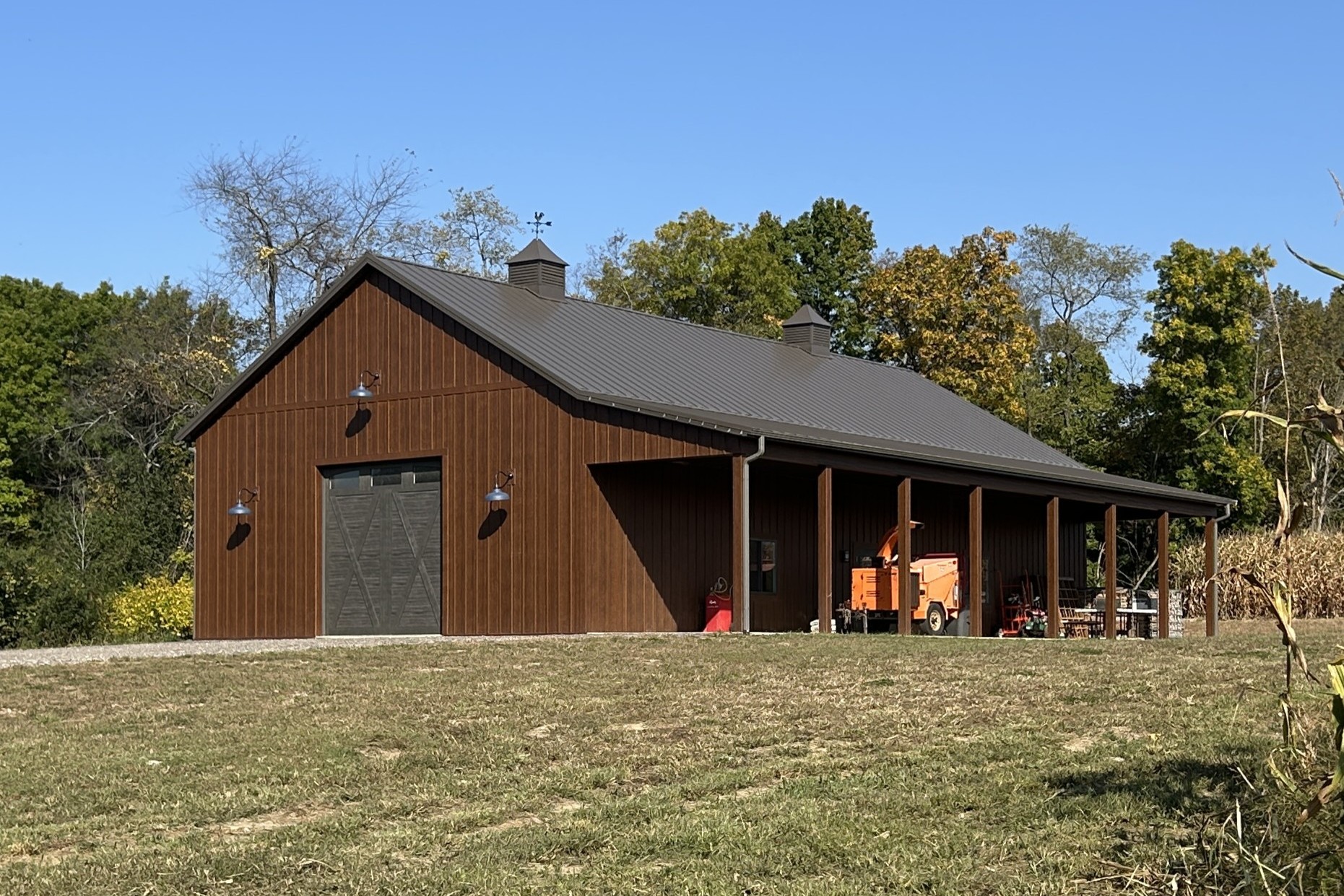 36' x 72' board and batten pole barn with LP SmartSide siding, Burnished Slate roof, and side porch
