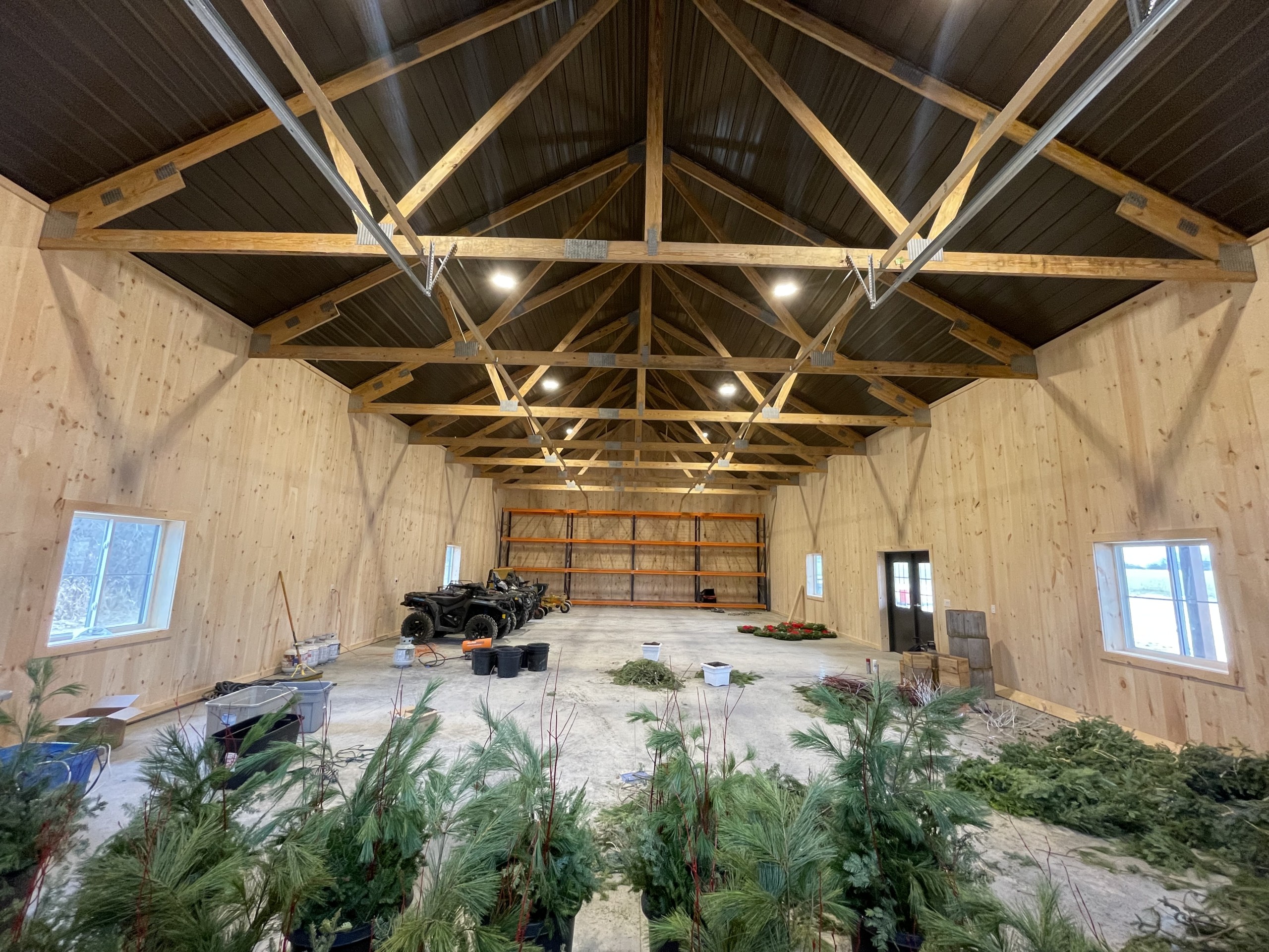 Interior of a 36' x 72' board and batten pole barn with rough-sawn pine walls and Burnished Slate steel between trusses