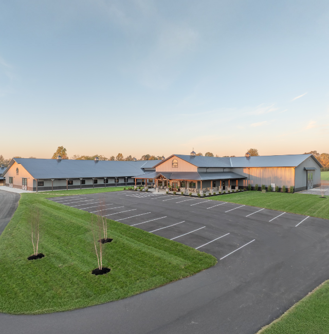 The Settlement Equestrian Center in Paducah, Kentucky with indoor riding arena, stall barn, and front lobby entrance