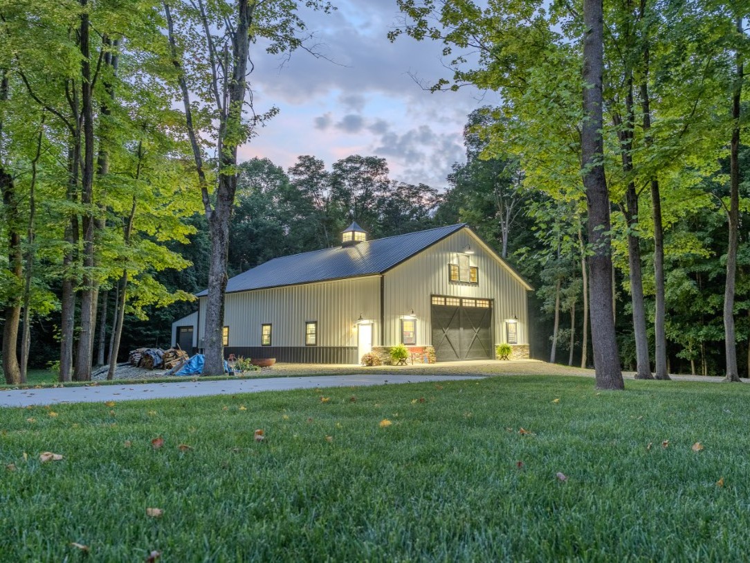 Custom pole barn storage building surrounded by mature trees on a wooded lot in Xenia, Ohio