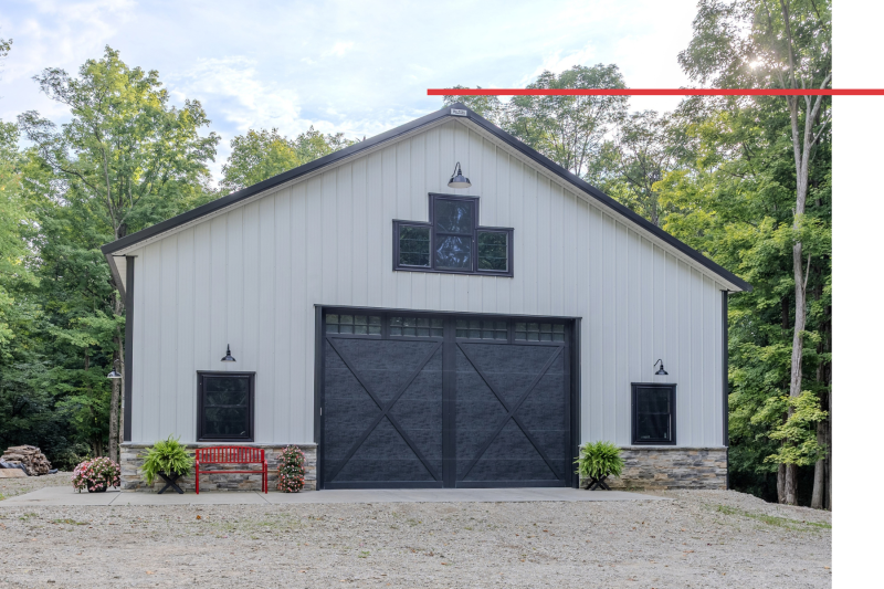 Custom Post-Frame Storage Building Front Elevation – Xenia, Ohio Front elevation of custom post-frame storage building with black overhead door, stone wainscot and gable windows