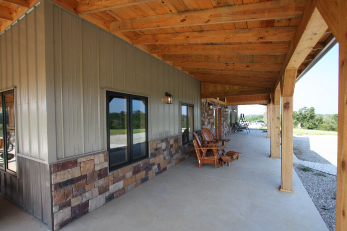 Open-concept timber frame interior with loft, exposed trusses, and vaulted ceiling