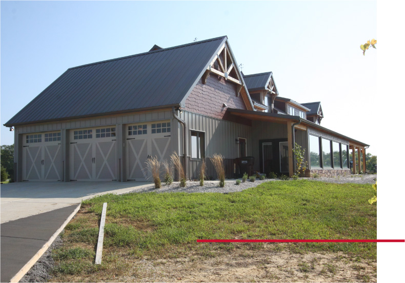 Rear view of timber frame home with wraparound porch in rural Kentucky setting