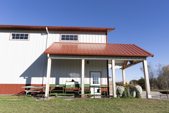 Interior of post-frame building with high ceilings, bright lighting, and open workspace designed for efficient agricultural storage and farm market operations