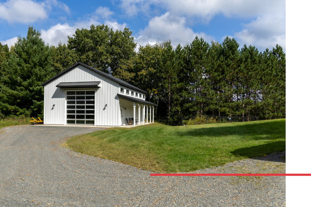 High-End 30′ x 48′ Pole Barn Garage 30' x 48' pole barn garage with white steel siding, black roof accents, side porch, and custom C.H.I. overhead door