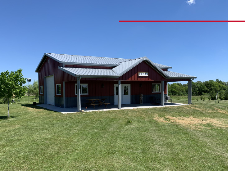 30x40 red pole barn garage with covered porch white steel roof and detached post frame construction