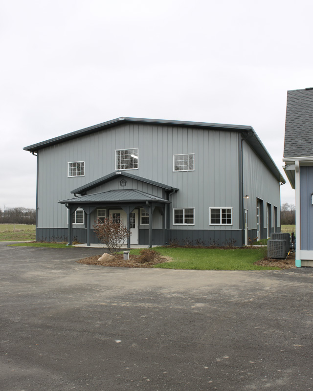 Indoor Basketball Court Building | Custom Sports Facility | Walters Buildings Indoor basketball court building with gray steel siding and custom post frame construction
