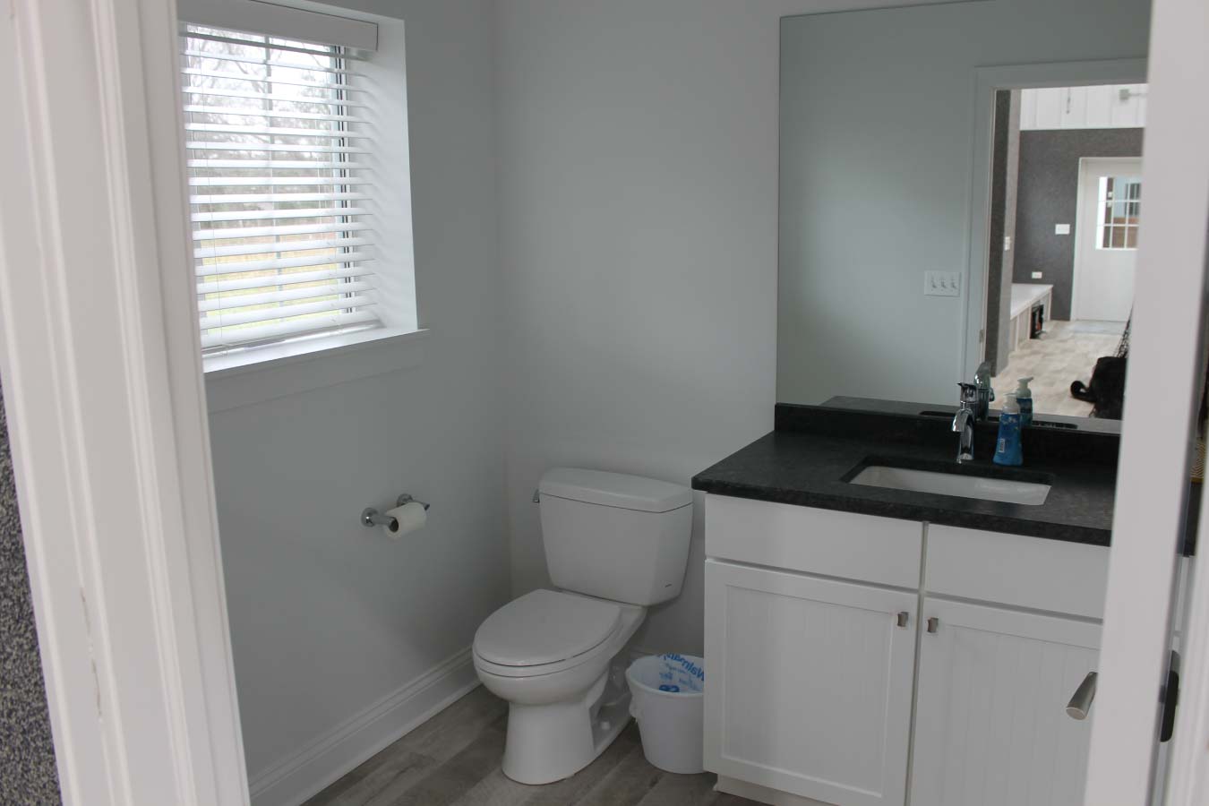 Finished bathroom inside private indoor basketball court building with modern fixtures and custom interior finishes