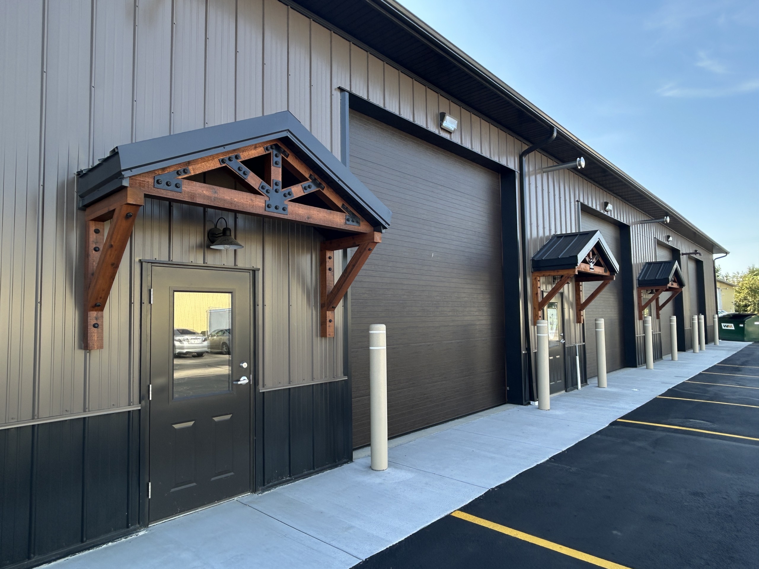 Commercial flex space walk doors with cedar truss entrance overhangs