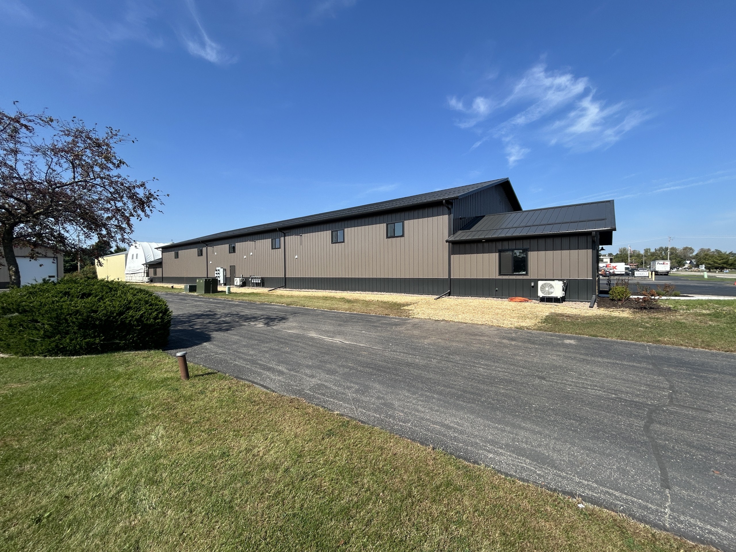 Rear of commercial flex space with high windows positioned above future mezzanine level