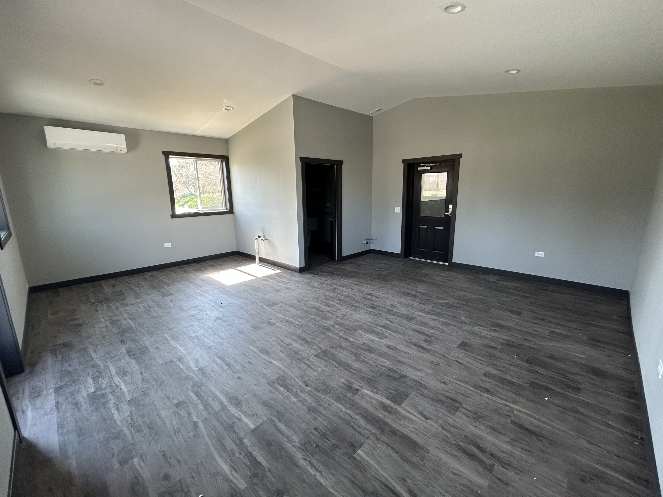 Interior of a commercial flex space office with windows and finished walls