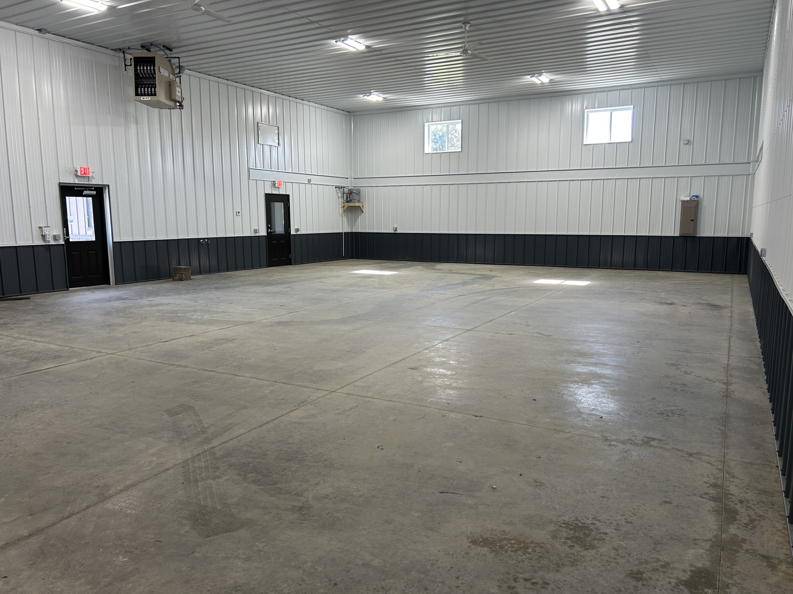 Interior of a larger commercial flex space end unit with concrete floor, floor drain and future mezzanine area