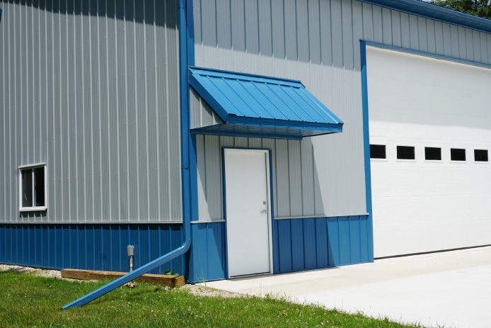 Eyebrow overhang entrance to custom post-frame storage building Eyebrow overhang entrance to custom post-frame storage building