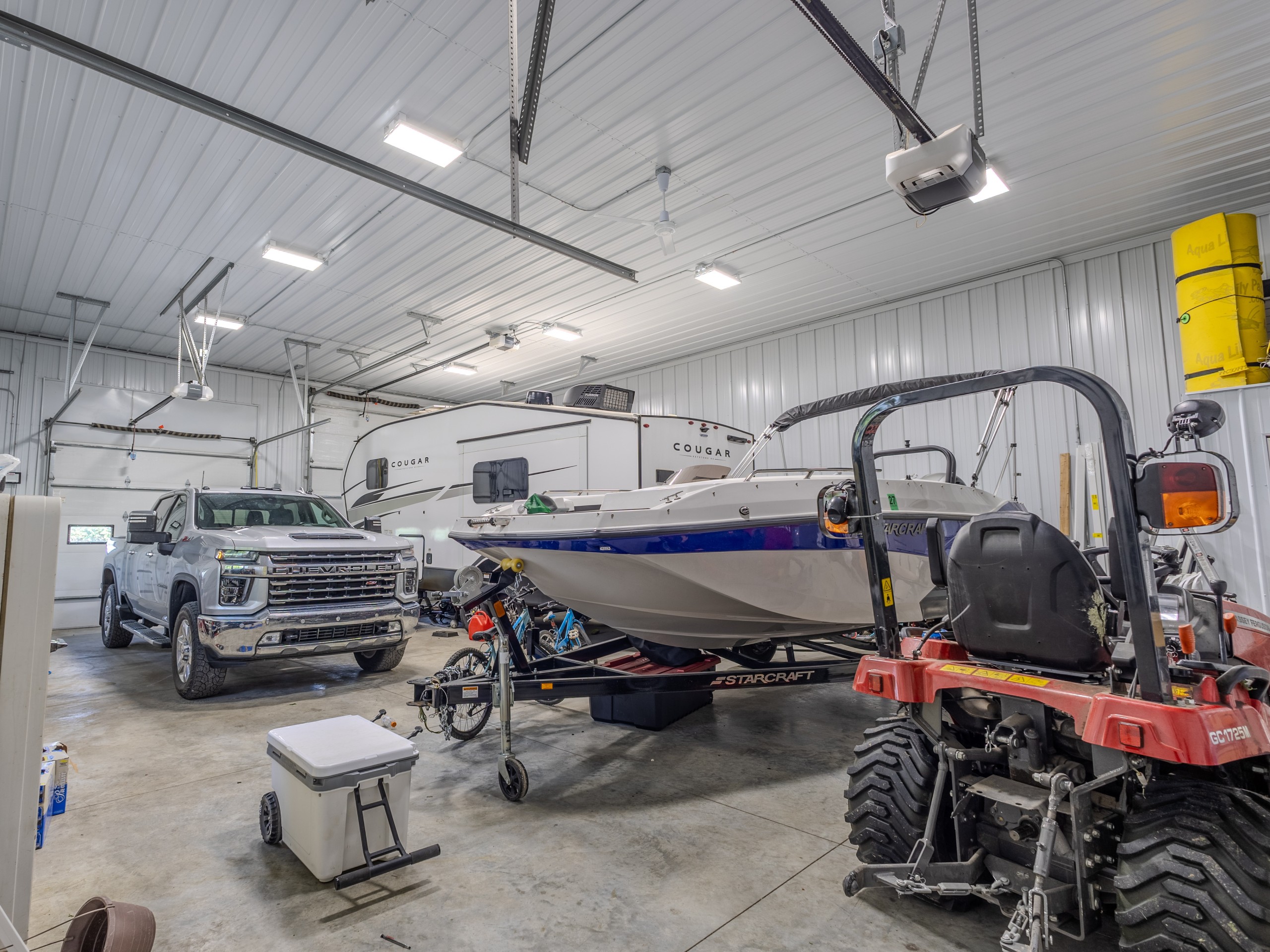 Insulated pole barn garage interior with white steel liner used for RV, boat and vehicle storage