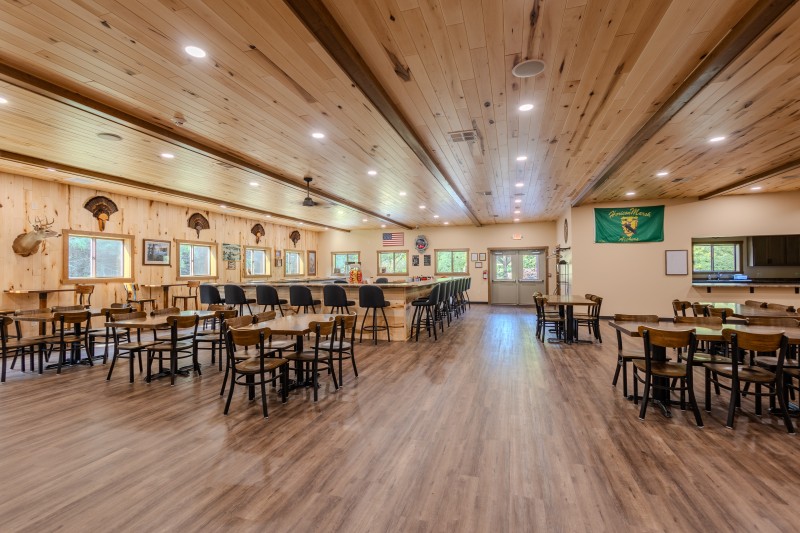 Interior of the Horicon Marsh Archers clubhouse with bar, seating and large gathering space