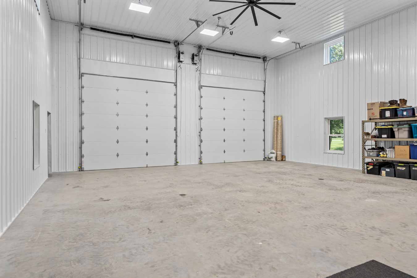 36' x 36' x 18' insulated post-frame garage with overhead doors and polished concrete floor.