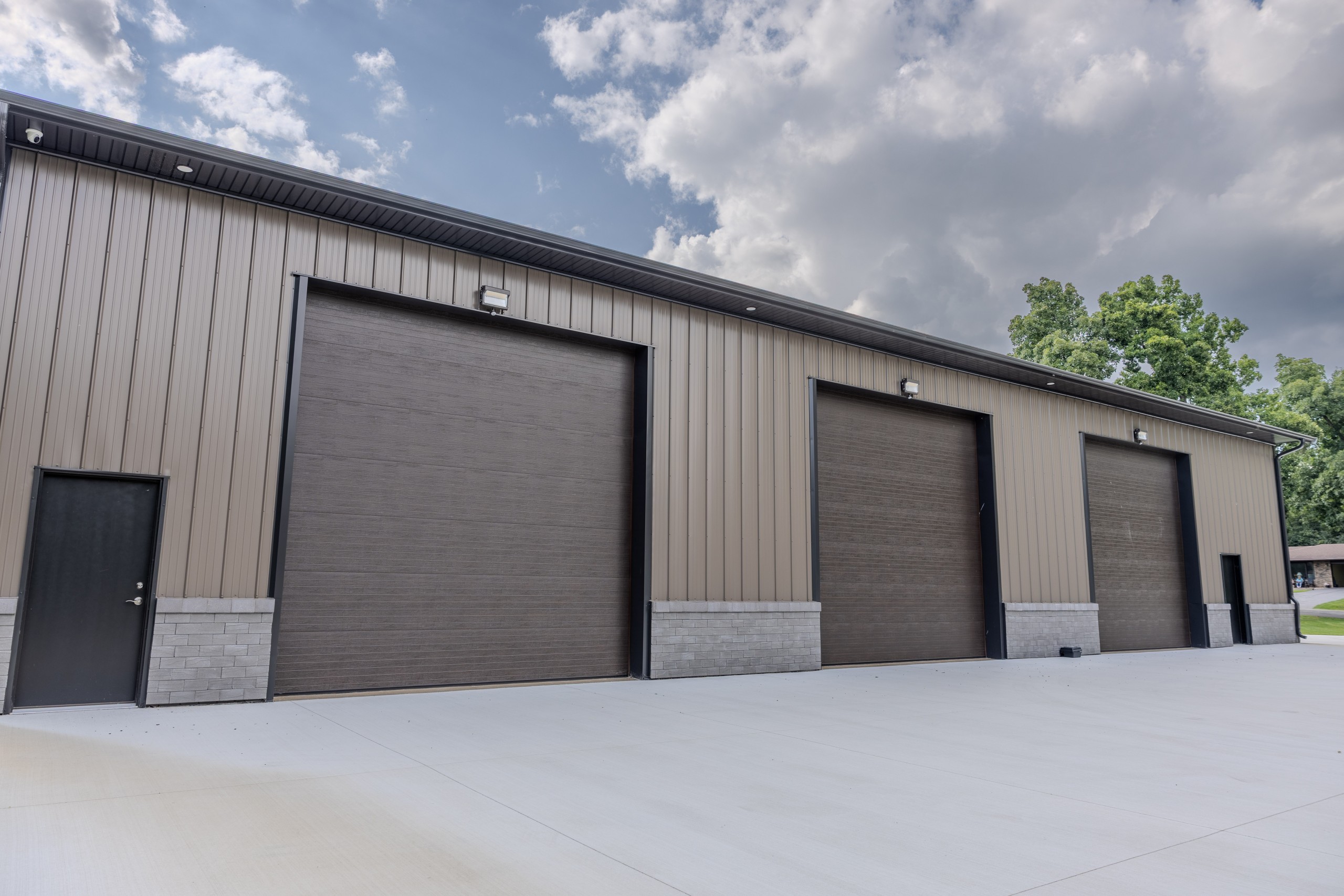 Four 14' x 14' insulated overhead garage doors providing access to a luxury car collector garage in Delavan, Wisconsin.