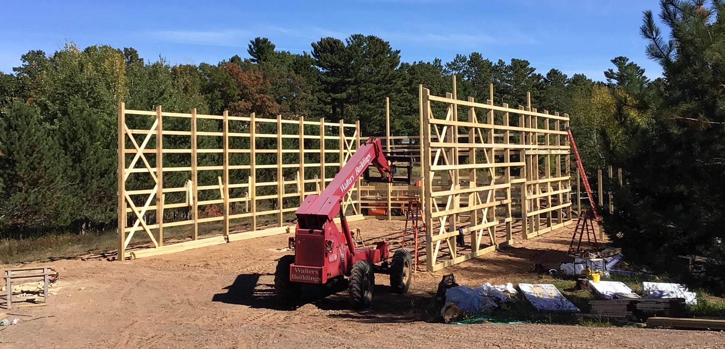 Pole barn with telehandler A pole barn under construction with a telehandler
